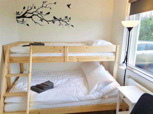 a bedroom with two bunk beds and a desk at Lynghagi House in Vegamót