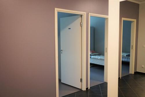 a room with two doors and a bedroom with a bed at Downtown Hostel in Tartu