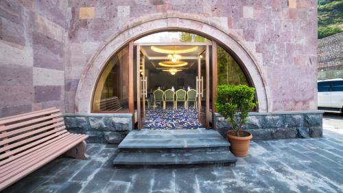 an entrance to a building with chairs and a staircase at Armenia Hotel in Jermuk
