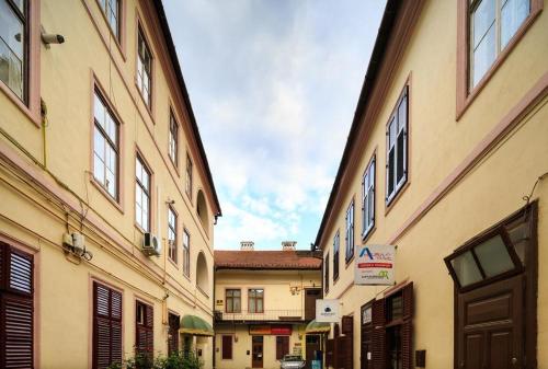 an alley between two buildings in a city at Casa Blanca in Sibiu