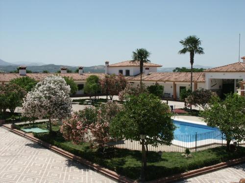 a view of a courtyard with trees and a swimming pool at Cortijo de Frías in Cabra