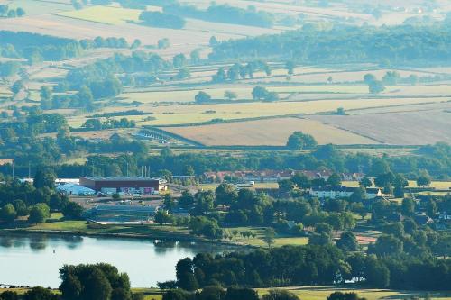 an aerial view of a town with a lake at Hotel ibis Autun in Autun