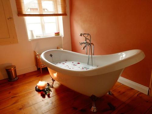 a white bath tub in a bathroom with a window at Moselvilla Enkirch in Enkirch