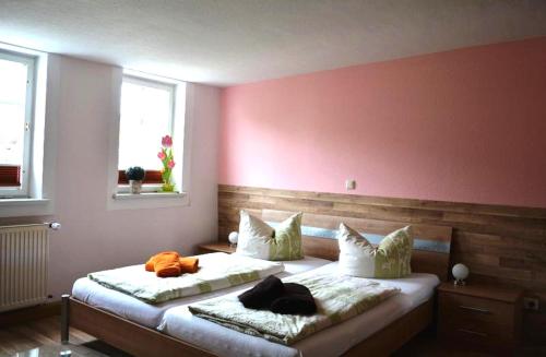 a bedroom with two beds with pillows on them at Ferienwohnungen "Altes Bachhaus" in Eisenach