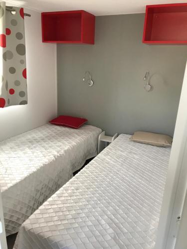 two beds sitting next to each other in a room at CosyStudio Site du Futuroscope in Chasseneuil-du-Poitou