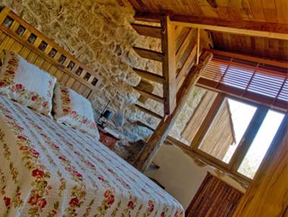 a bedroom with a bed and a large window at Arqueixal Ecoagroturismo in Albá