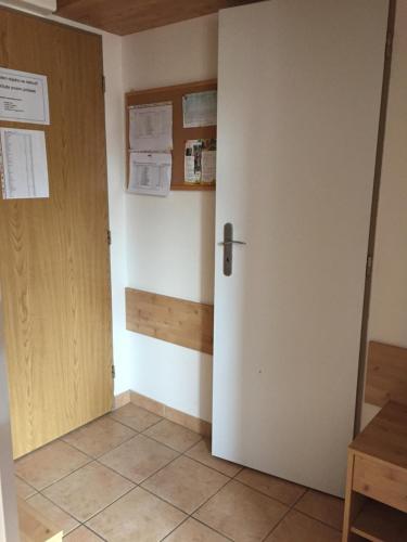 a room with a door and a tiled floor at Orbit Karlov pod Pradědem in Malá Morávka