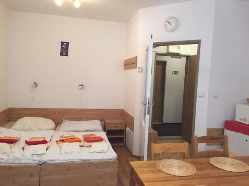 a bedroom with a bed and a table and a mirror at Orbit Karlov pod Pradědem in Malá Morávka