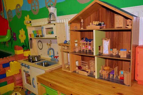 a play kitchen with a doll house and a toy kitchen at Chalet Tschallener in Ried im Oberinntal