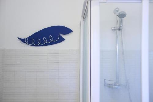 a whale sign on a wall next to a shower at Trullo Riccardo in Ostuni