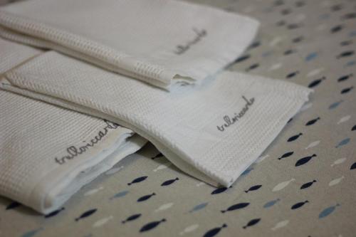two stacks of white towels sitting on a table at Trullo Riccardo in Ostuni