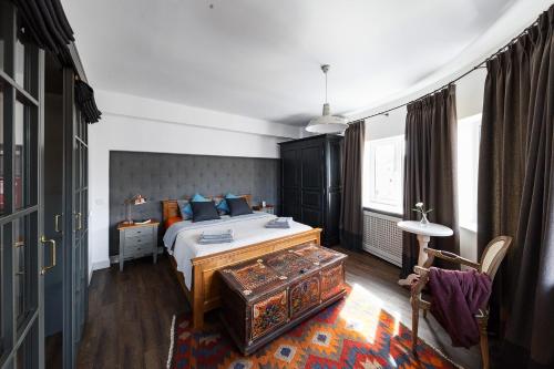 a bedroom with a bed with blue pillows at Bohemian Old Town Boutique Apartment in Bucharest