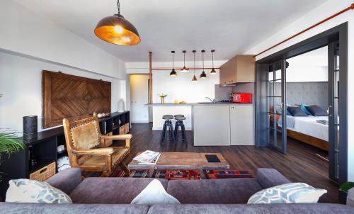 a living room with a couch and a room with a bed at Bohemian Old Town Boutique Apartment in Bucharest