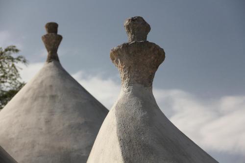 two white dresses sitting on top of each other at Trullo Riccardo in Ostuni