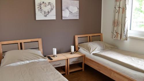 a room with two beds and a table with candles at Sunseitn Apartments in Gosau
