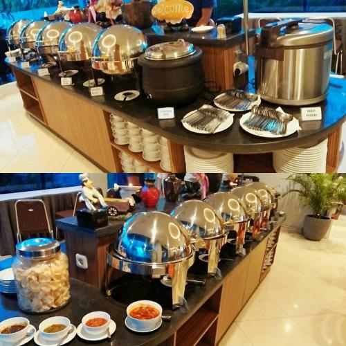 a buffet line with dishes and pots and pans at News Hotel Waru Sidoarjo in Waru