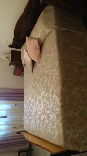 a bed with a pillow on top of it at Agriturismo dal Poeta in Madonna di Fornelli