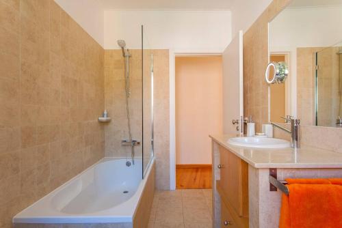 a bathroom with a tub and a sink at Santos River View Terrace Duplex in Lisbon