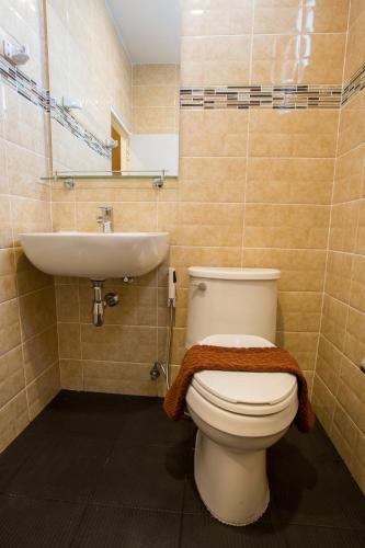 a bathroom with a toilet and a sink at Pongsakorn Boutique Resort in Lat Krabang
