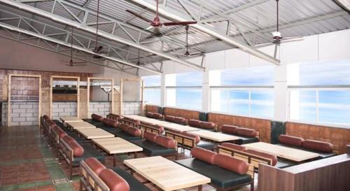 a classroom with tables and chairs in a building at Nakshatra Residency in Ambernath