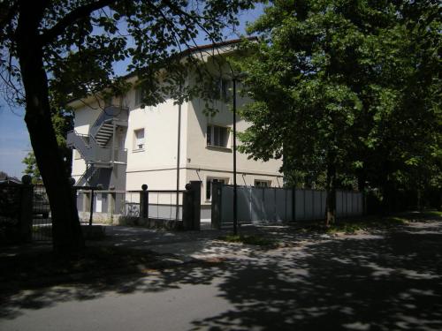 a white building with a staircase in front of it at Vila Ema Apartments and Rooms in Ljubljana