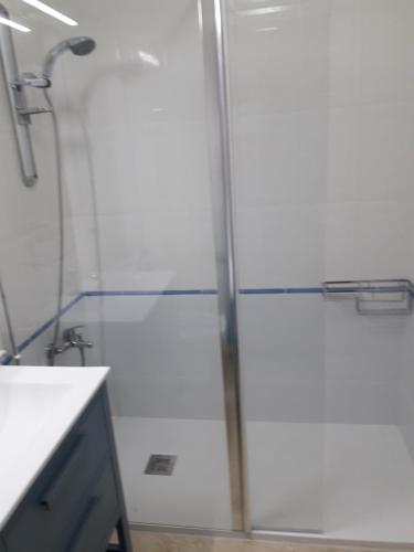a bathroom with a shower with a glass door at Albir Sunshine Apartments in Albir