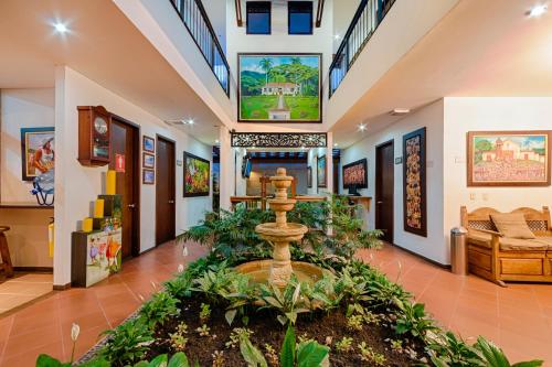 a lobby with a fountain in the middle of a room at Hotel Boutique San Antonio in Cali