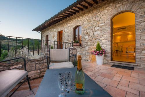 a bottle of wine sitting on a table on a patio at Antica Fonte in Assisi
