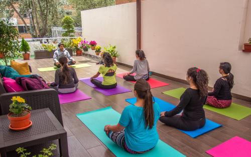 a group of children sitting in a yoga class at El Patio Hostel Quito in Quito