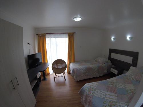 Ein Bett oder Betten in einem Zimmer der Unterkunft Apart Hotel Escala Real
