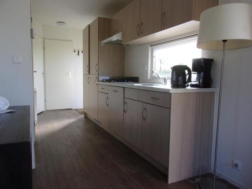 a kitchen with a counter and a sink and a window at Holiday rentals in Velsen-Zuid
