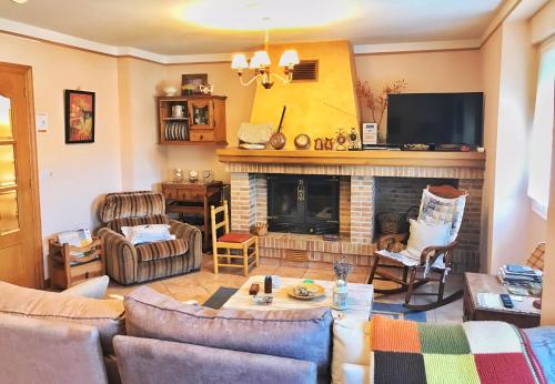 a living room with couches and a fireplace at La Aldaia de Urbasa in Eulate