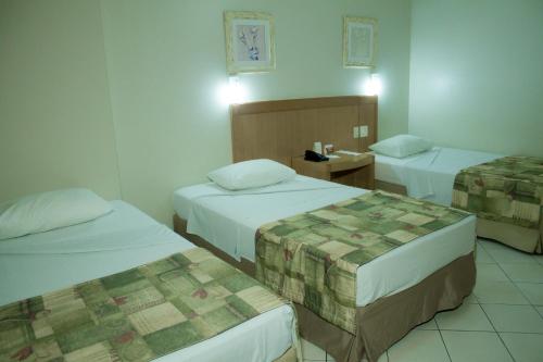 Tempat tidur dalam kamar di Oft San Conrado Hotel