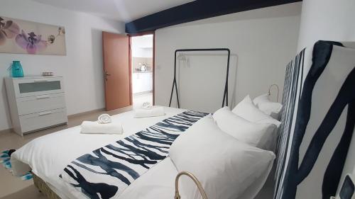 En eller flere senge i et værelse på Hili Apartments