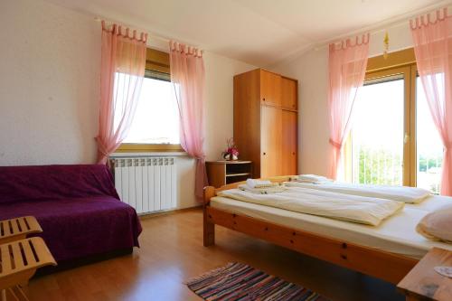 Кровать или кровати в номере Ferienhaus Tomic