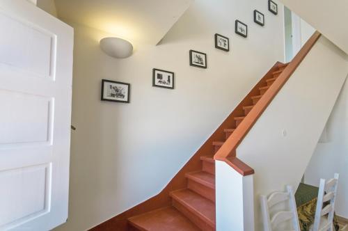 a staircase with framed photos on the wall at Magoito1 in Sintra
