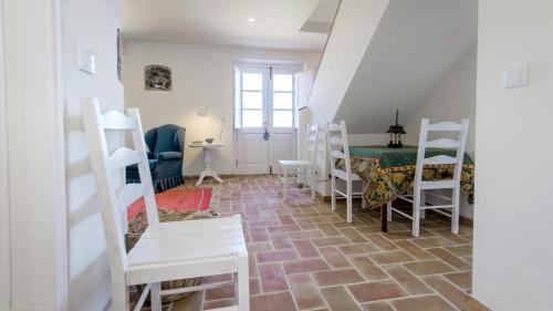 a room with white chairs and a table and a staircase at Magoito1 in Sintra