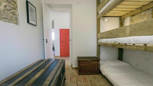 a room with two bunk beds and a red door at Magoito1 in Sintra