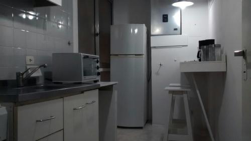 a kitchen with a white refrigerator and a sink at Apartamento Recoleta in Buenos Aires