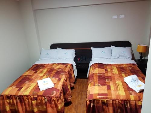 two beds sitting next to each other in a room at Imperio Tanpu Q in Lima