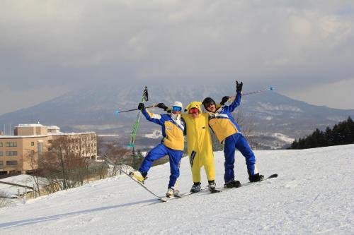 a group of four people on a ski slope at Annupuri Oasis Lodge in Kutchan
