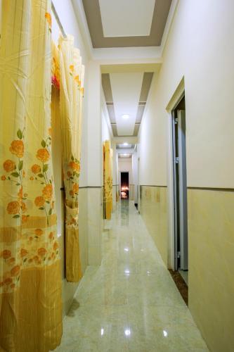 a hallway in a building with paintings on the walls at Khách Sạn Hoàng Thông Lý Sơn in Ly Son