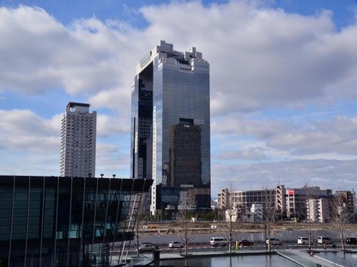 a city skyline with tall skyscrapers in a city at Hotel Wing International Select Osaka Umeda in Osaka