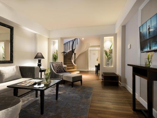 a living room with a couch and a table at Melia Purosani Yogyakarta in Yogyakarta