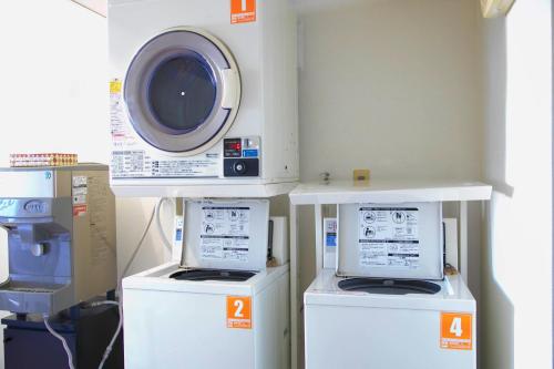 a room with two machines and a washing machine at Mito Hotel Season in Mito