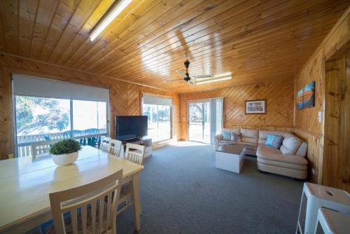 a living room with a table and a couch at Mundic Waterfront Cottages in Renmark