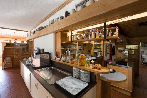 a kitchen with a counter with a sink in it at Landhotel Maiergschwendt inkl Chiemgaukarte in Ruhpolding
