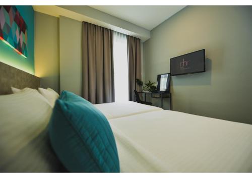 a hotel room with two beds and a tv at RHR Hotel - Selayang in Batu Caves