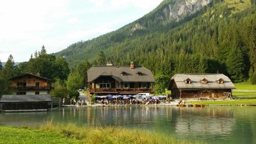 a group of buildings sitting next to a lake at Oberrainbauer in Kleinarl