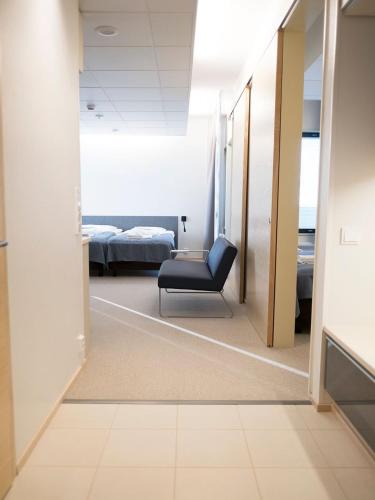 a room with a chair and a bed at Santasport Resort in Rovaniemi